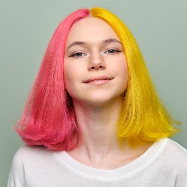 Headshot of fashionable beautiful teen girl with trendy dyed hair
